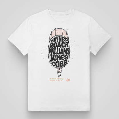 Close-up view of the Classic Drums Heroes white t-shirt with drumstick-shaped design listing famous jazz drummers.